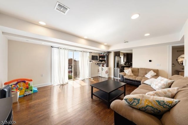 living room with visible vents, recessed lighting, baseboards, and dark wood-type flooring