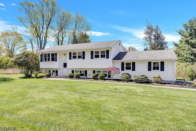 raised ranch featuring a front lawn