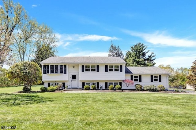 raised ranch with a front lawn