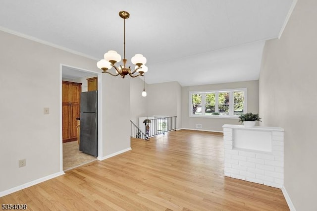 interior space featuring baseboards, a chandelier, and light wood-type flooring