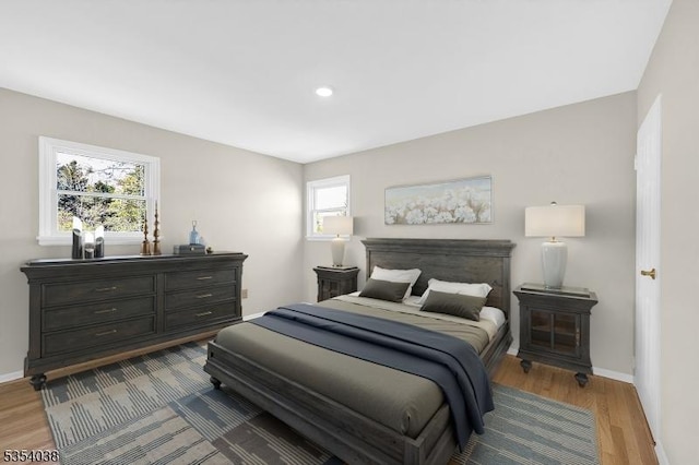 bedroom with baseboards, recessed lighting, and wood finished floors