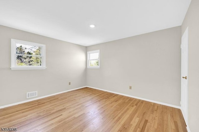 spare room featuring recessed lighting, baseboards, light wood finished floors, and visible vents