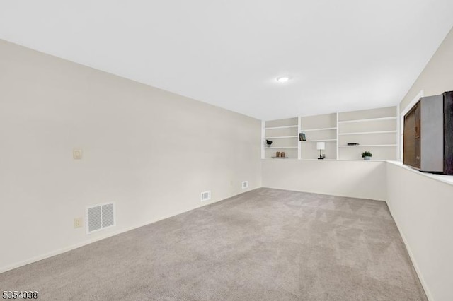 carpeted spare room featuring recessed lighting, baseboards, and visible vents