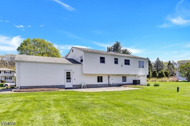 back of property featuring a lawn, a patio, and central AC unit