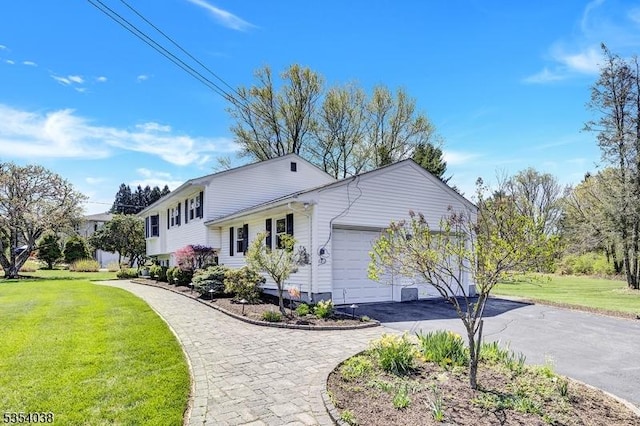 exterior space featuring an attached garage, driveway, and a front lawn