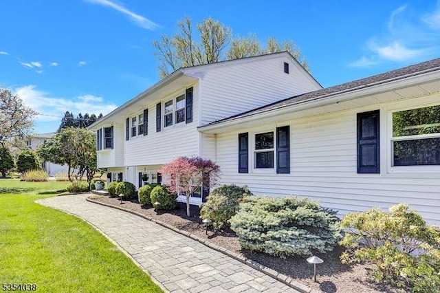 view of side of home featuring a lawn