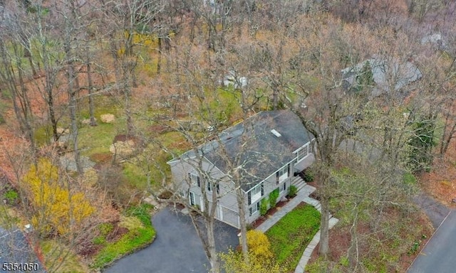 birds eye view of property with a forest view