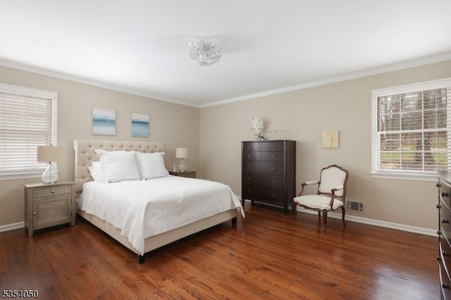 bedroom with crown molding, baseboards, and dark wood-style floors