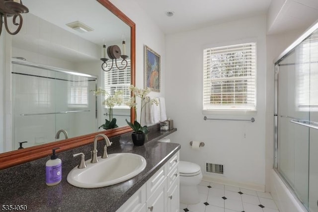 full bathroom featuring visible vents, an enclosed shower, vanity, baseboards, and toilet