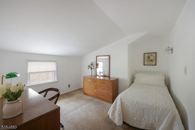 carpeted bedroom with baseboards, multiple windows, and lofted ceiling