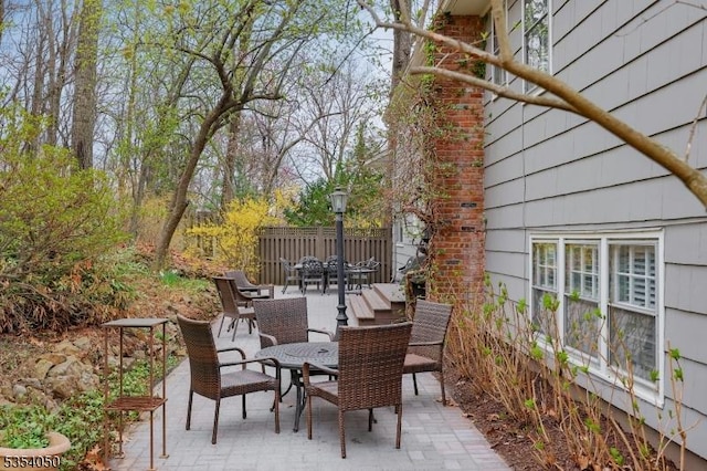 view of patio featuring fence and outdoor dining area