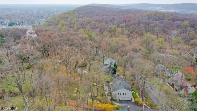 drone / aerial view featuring a wooded view