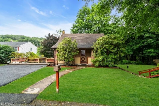 51 Meggins Rd, Rockaway Twp, NJ 07866 - view of front of property featuring a front lawn, a chimney, driveway, and roof with shingles