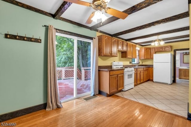 51 Meggins Rd, Rockaway Twp, NJ 07866 - kitchen with white appliances, beam ceiling, dark countertops, light wood-style floors, and a ceiling fan