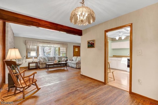 sitting room with light wood-type flooring, baseboards, beamed ceiling, cooling unit, and a chandelier