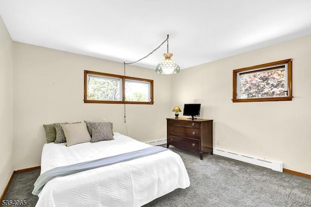 carpeted bedroom featuring baseboards and a baseboard radiator