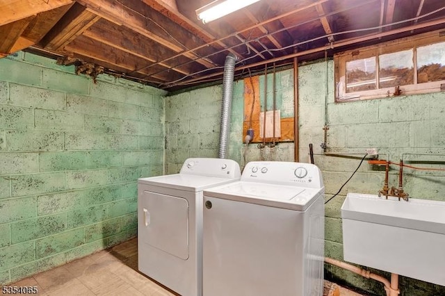 laundry room with a sink, laundry area, and independent washer and dryer