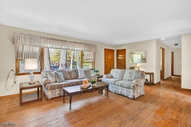 living room featuring cooling unit and light wood-style floors