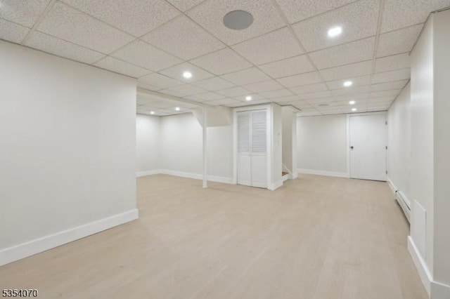 finished below grade area featuring recessed lighting, baseboards, and wood finished floors