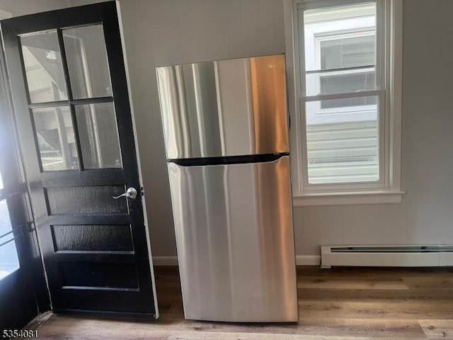 914 S St, Elizabeth City, NJ 07202 - interior space featuring wood finished floors, freestanding refrigerator, and a baseboard heating unit