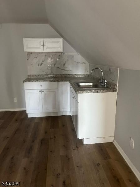 914 S St, Elizabeth City, NJ 07202 - additional living space featuring dark wood-style flooring, baseboards, a sink, and lofted ceiling