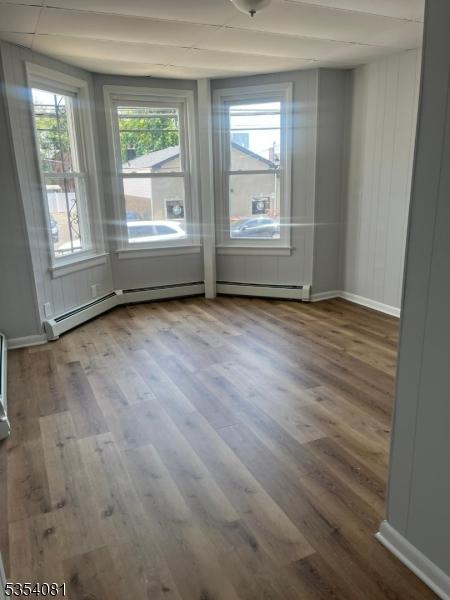 914 S St, Elizabeth City, NJ 07202 - unfurnished room with a baseboard heating unit and wood finished floors