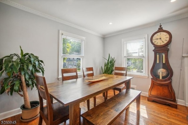 dining room with crown molding, recessed lighting, baseboards, and light wood-style floors