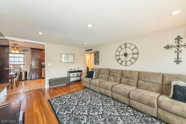 living area featuring baseboards, ceiling fan, recessed lighting, and wood finished floors