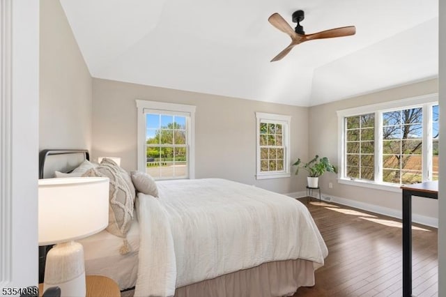 bedroom featuring baseboards, a ceiling fan, dark wood finished floors, and lofted ceiling