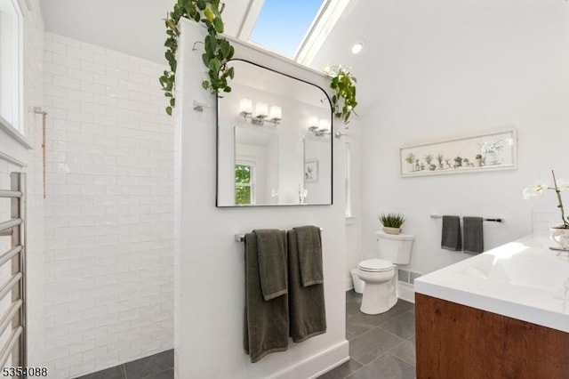 bathroom featuring vanity, a walk in shower, a wealth of natural light, and toilet