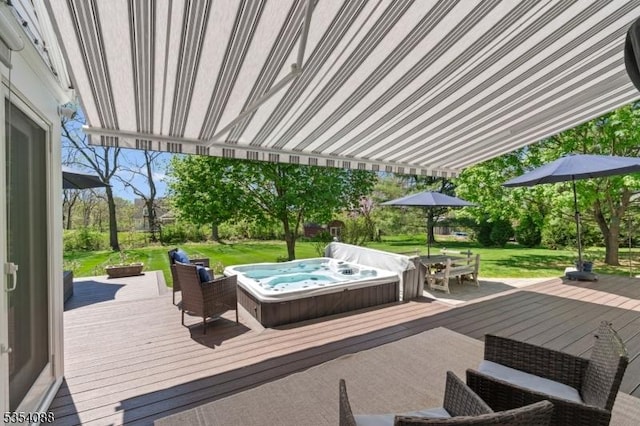 wooden terrace with a lawn, outdoor dining space, and hot tub deck surround