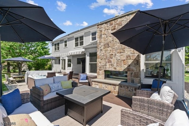 view of patio featuring an outdoor living space with a fireplace