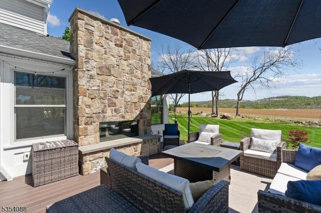 view of patio / terrace with an outdoor living space with a fireplace