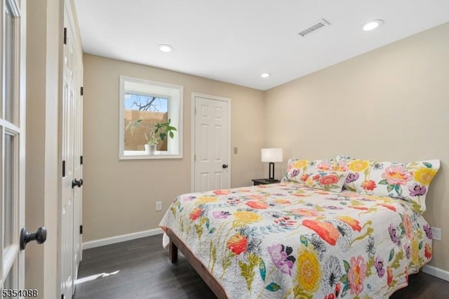 bedroom with visible vents, recessed lighting, dark wood finished floors, and baseboards