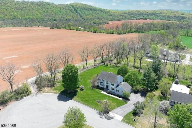 birds eye view of property featuring a view of trees