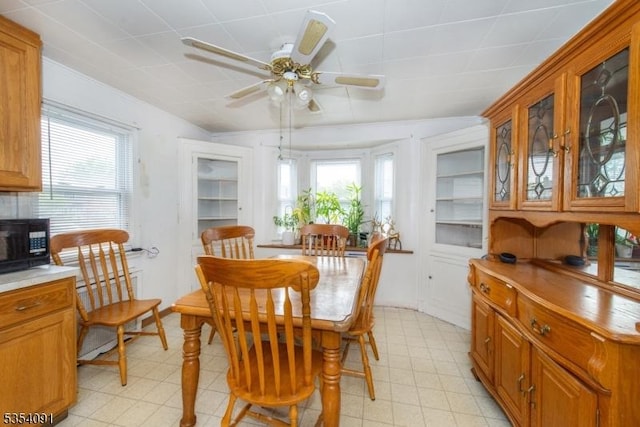 dining room featuring ceiling fan, plenty of natural light, and light floors
