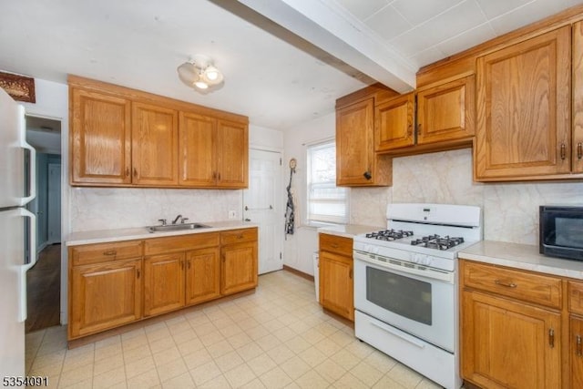 kitchen with decorative backsplash, white appliances, light countertops, brown cabinets, and a sink