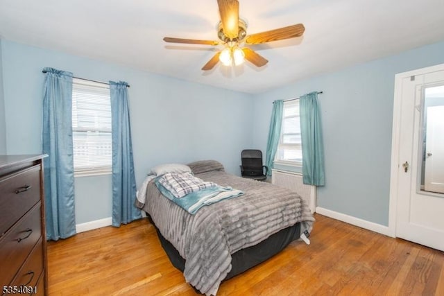 bedroom with baseboards, light wood-style floors, and ceiling fan