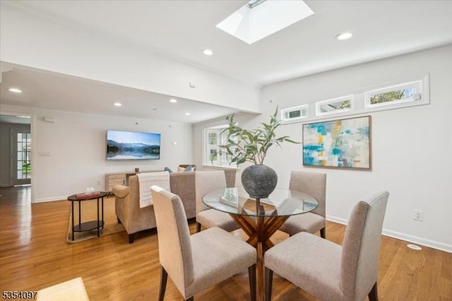 dining area featuring recessed lighting, baseboards, and light wood finished floors