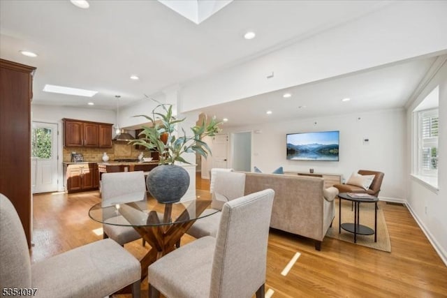 dining space with recessed lighting, baseboards, and light wood-style floors