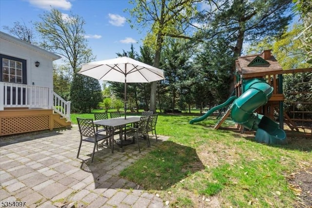 exterior space with a lawn, outdoor dining space, and a patio area