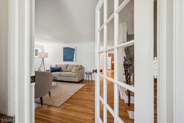 living room featuring crown molding, french doors, and wood finished floors