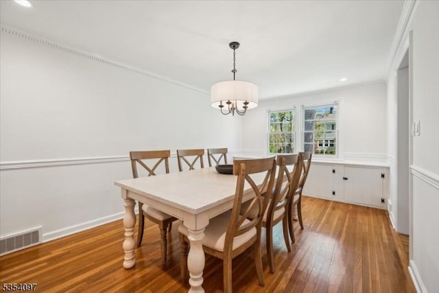 dining space with visible vents, hardwood / wood-style flooring, baseboards, a notable chandelier, and recessed lighting