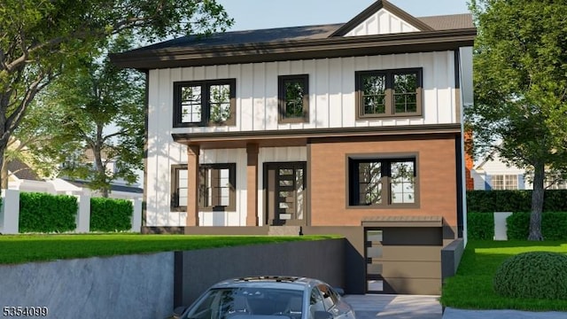 view of front of house with board and batten siding, an attached garage, and driveway