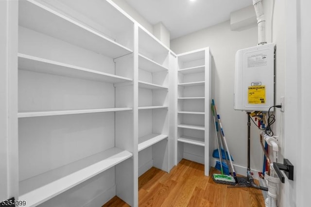 pantry featuring tankless water heater