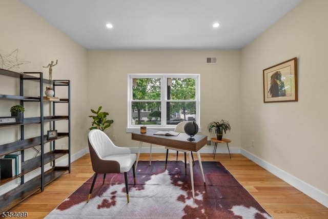 office space with wood finished floors, recessed lighting, and baseboards
