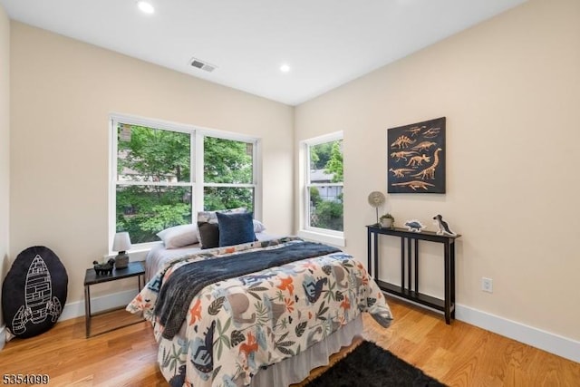 bedroom with light wood finished floors, baseboards, and recessed lighting
