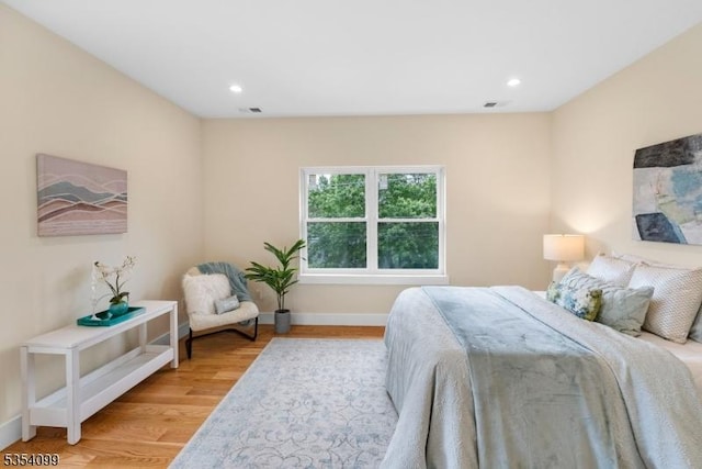 bedroom featuring light wood-type flooring, baseboards, and recessed lighting