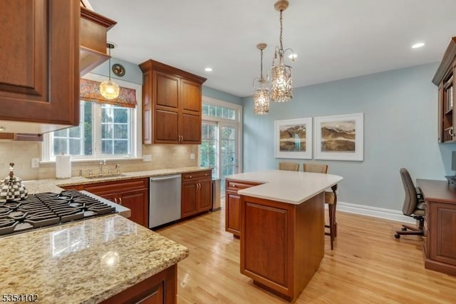 kitchen featuring a sink, decorative backsplash, light wood-style floors, and dishwasher