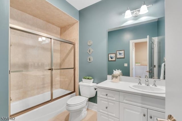 bathroom with vanity, combined bath / shower with glass door, and toilet